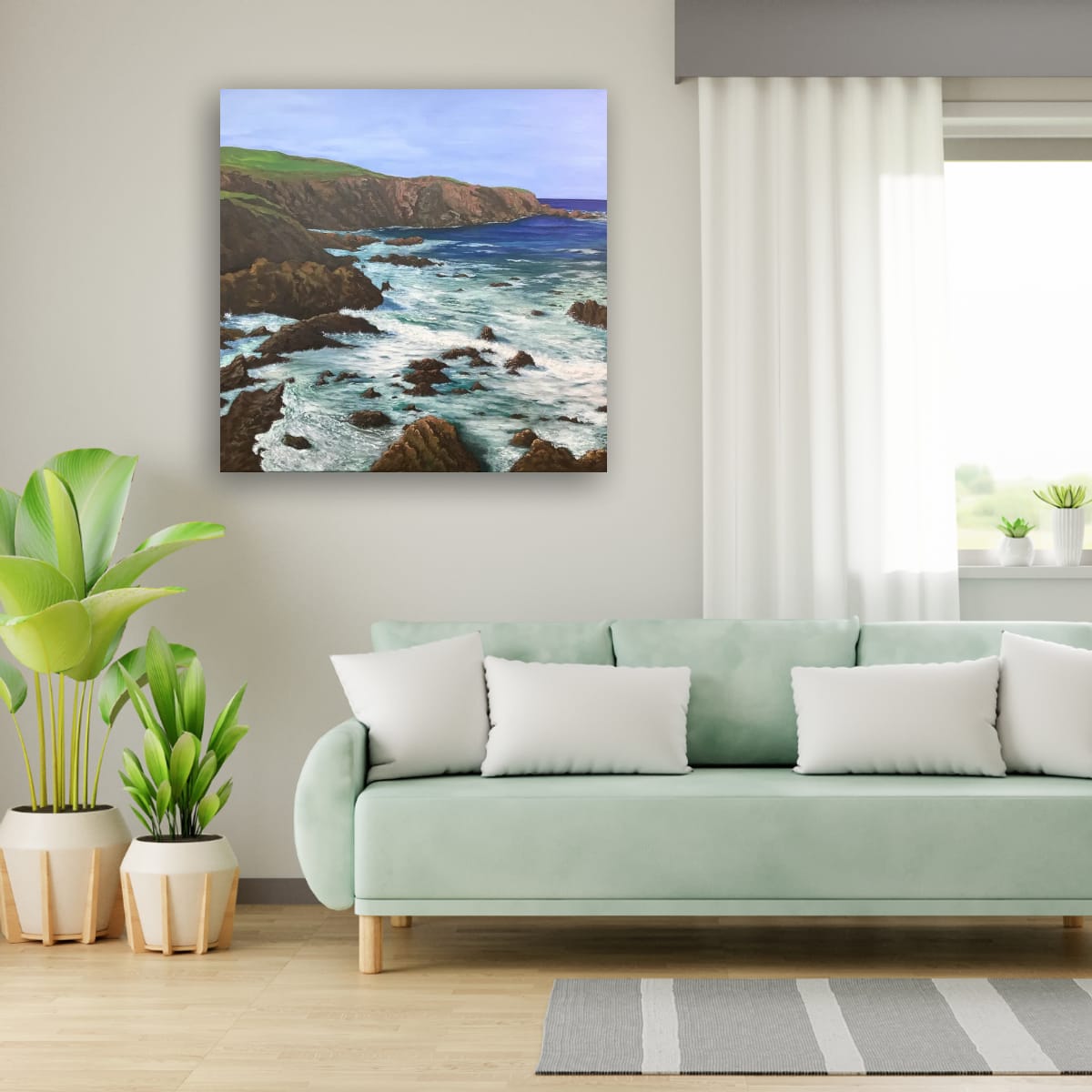 A canvas print of a seascape compliments the cool colour of the furniture